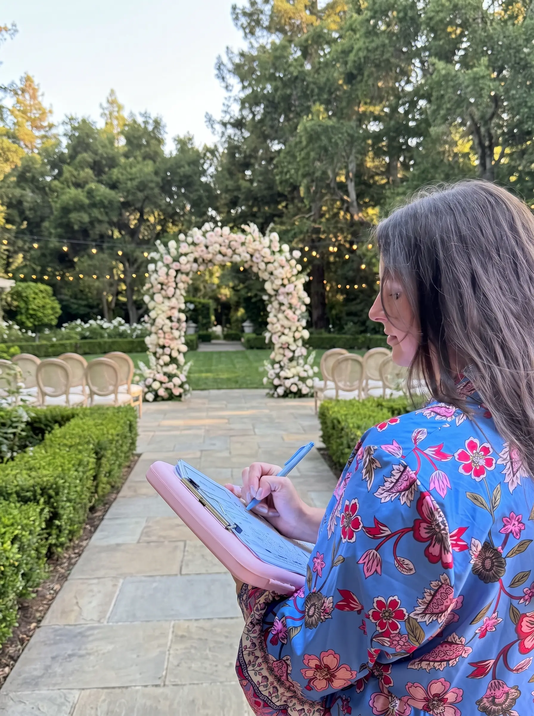 Wedding planner reviewing details in a courtyard venue